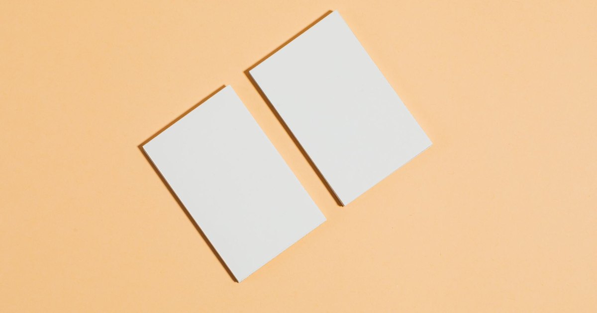 Flat lay of two blank cards on a peach background. Perfect for business concept layouts.