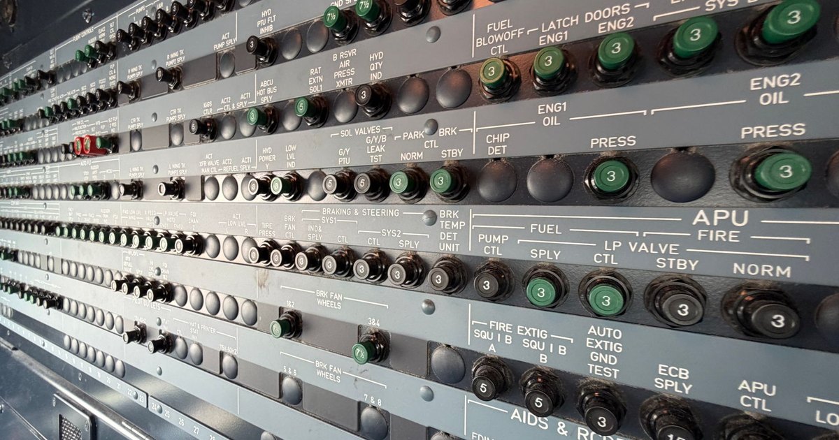 Detailed view of an airplane avionics control panel featuring numerous switches and indicators.
