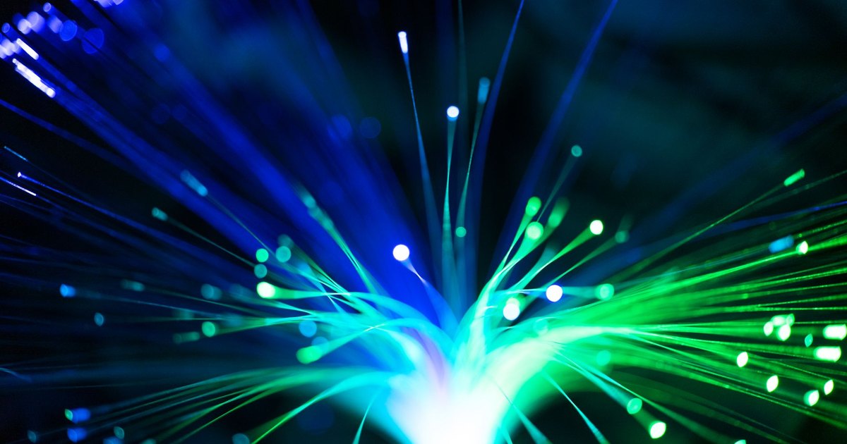Close-up of illuminated fiber optic lights in blue and green colors, showcasing modern technology.