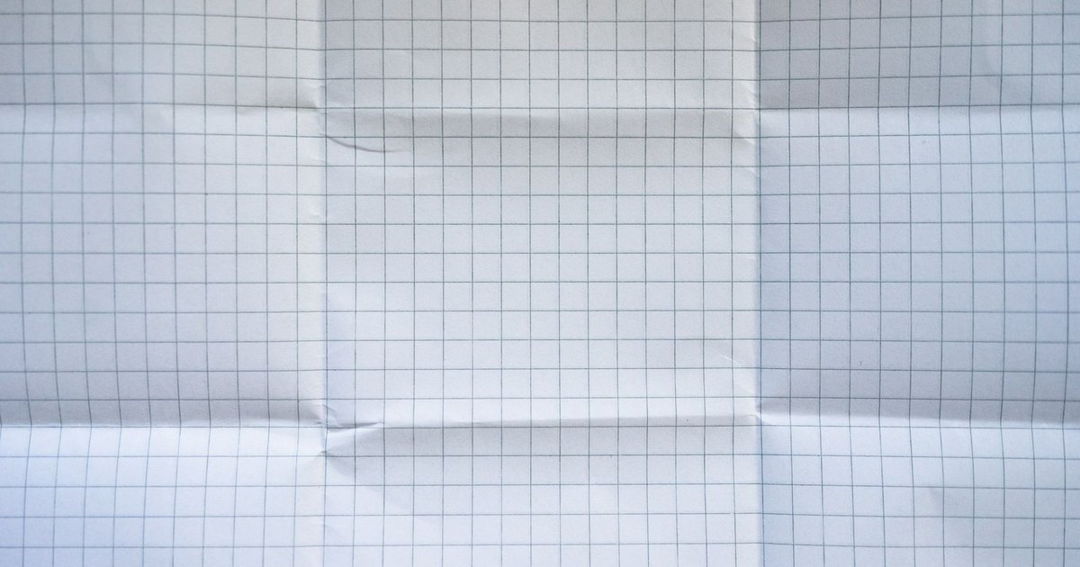 Close-up of a wrinkled grid paper texture with folded creases.