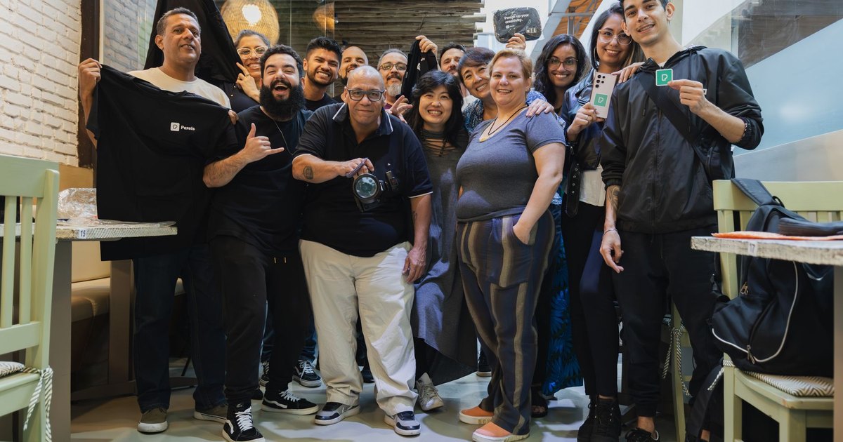 A diverse group of colleagues posing together, showcasing team spirit and camaraderie indoors.