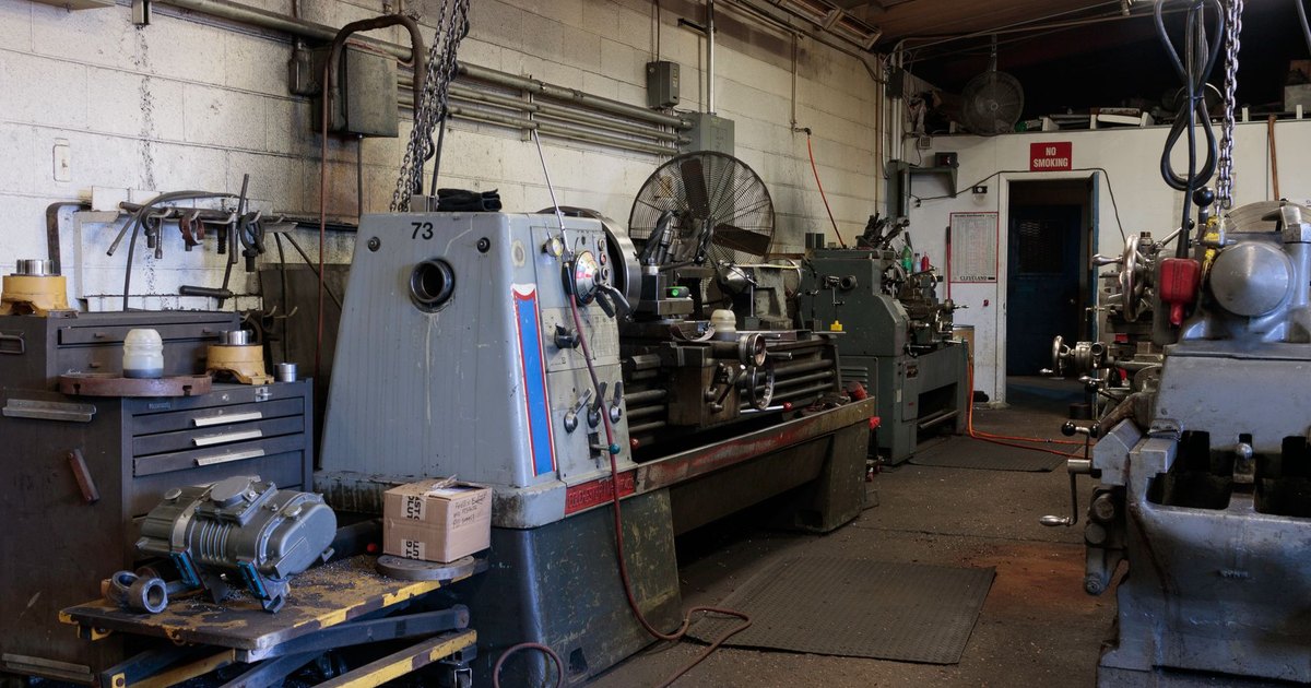 Interior of a workshop featuring various industrial machines and equipment for metalwork.