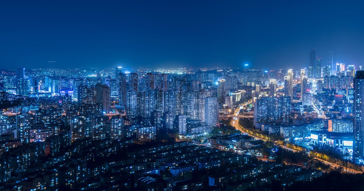 A breathtaking cityscape with illuminated skyscrapers and vibrant urban lights during the night.