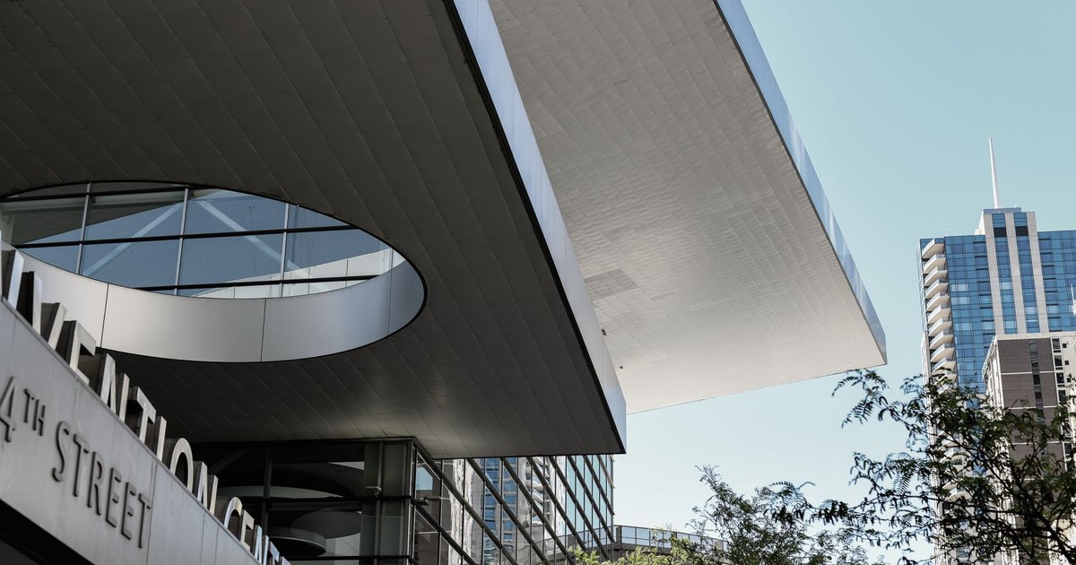 Dynamic view of the Denver Convention Center's architecture with city skyline.