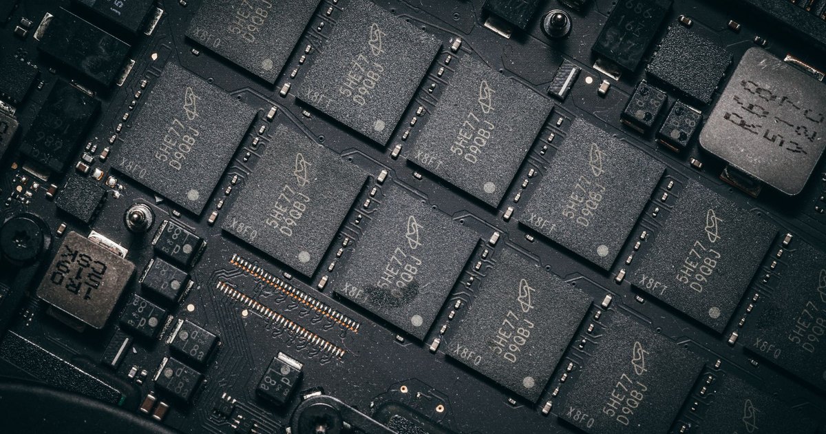 Detailed view of electronic circuit board components showcasing microchips and technology intricacies.