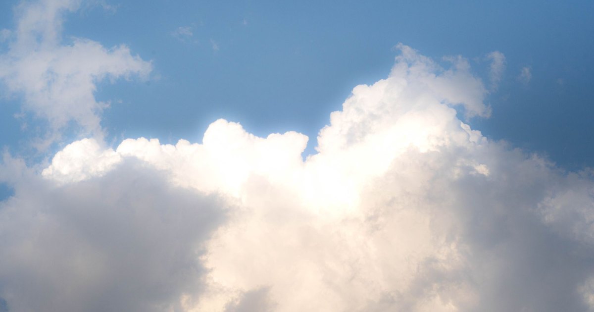 A serene view of fluffy white clouds against a vibrant blue sky, perfect for backgrounds.